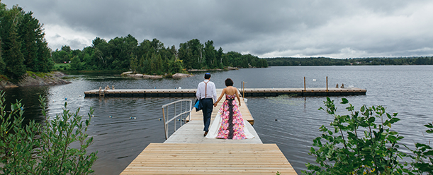 bride and groom on swim dock