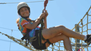 girl in harness on ropes course